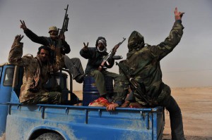 Libyan rebel fighters flash the "victory