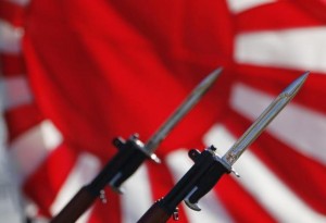 Bayonets attached to rifles used by Japanese Self-Defense Forces are seen in front of Japan's rising sun flag, which is used by the forces, during annual troop review ceremony at Asaka Base