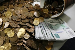 Russian 1000-rouble banknotes, 50 and 10 kopeck coins are seen at a private company's office in Krasnoyarsk